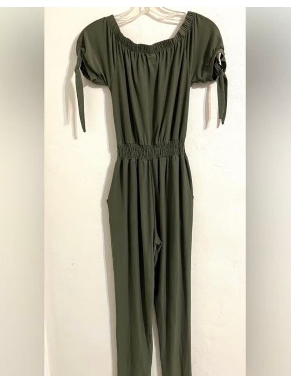 Make a statement in this stylish olive green jumpsuit by Derek Heart.